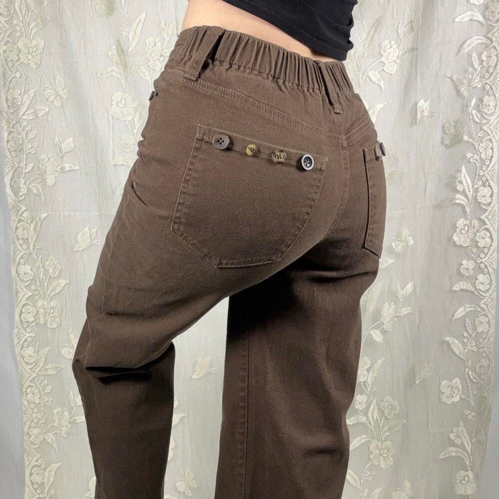 Brown straight leg pants with button details and elastic waistband